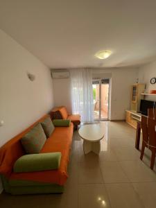 a living room with a couch and a table at Apartments Bojka in Promajna