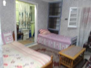 a toy bedroom with two beds and a table at 35 ادفو علي امين in Alexandria