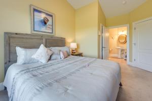 a bedroom with a large white bed with pillows at 3 Mi to Beach - Edgewater at Barefoot Resort Condo in Myrtle Beach +18 photos
