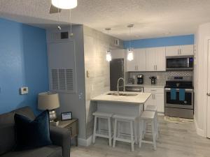 a kitchen with a sink and a stove top oven at Villa del Sol in Kissimmee