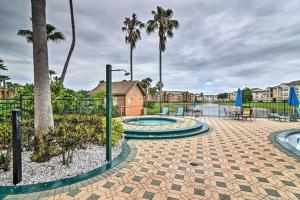 a courtyard with two fountains and palm trees at Villa del Sol in Kissimmee