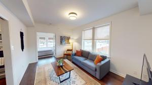 a living room with a couch and a table at Nashville West End Getaway in Nashville