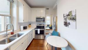 a kitchen with a sink and a stove top oven at Nashville West End Getaway in Nashville