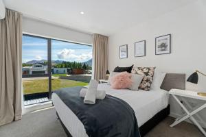 a bedroom with a bed and a large window at Willow Lane in Albert Town