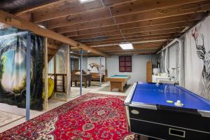 a room with a pool table on a red rug at Hot Tub, Deck, Grill, Fire Pit, Game Room & WiFi in Great Cacapon