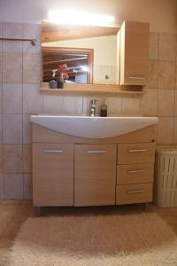 a bathroom with a sink and a person in a mirror at The country house in Paramonas +22 photos