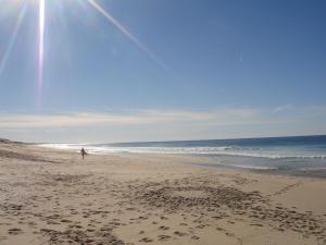 a person flying a kite on the beach at Ponte Pedra Melides -Nature & Ocean- Adults Only in Melides