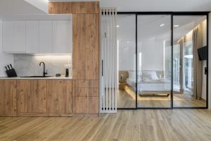 a kitchen and living room with wooden flooring at Central Sunny Loft with Plunge Pool in Athens +20 photos