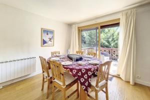 a dining room with a table and chairs at Chalet Les Lutins - Un cocon élégant au cœur des Allues MAE-4864 in Les Allues
