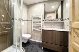 a bathroom with a toilet and a sink and a shower at Chalet Les Lutins - Un cocon élégant au cœur des Allues MAE-4864 in Les Allues +9 photos