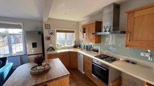 a kitchen with wooden cabinets and a counter top at Cosy Corner in Midhurst