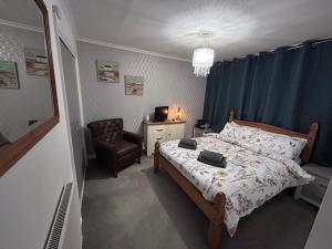 a small bedroom with a bed and a chair at Park House in Leicester +16 photos
