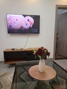 a living room with a vase of flowers on a table at Kilimani Luxurious 2 bedroom in Nairobi