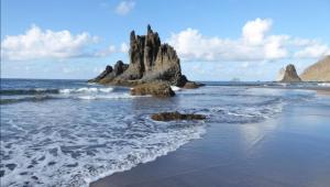 a rock formation in the water on a beach at Casa lucas in Almáciga