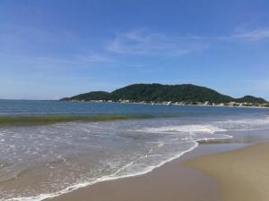 plaża z oceanem i górami w tle w obiekcie Vento e Vida w mieście São Francisco do Sul