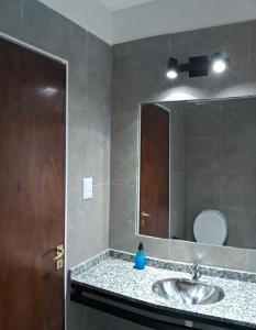 a bathroom with a sink and a mirror at Departamento 1 Sarmiento in San Fernando del Valle de Catamarca