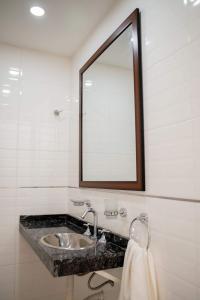 a bathroom with a sink and a mirror at Apart Valeria cerca del Mar in Valeria del Mar