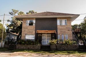 a brick house with a porch and a door at Apart Valeria cerca del Mar in Valeria del Mar +7 photos