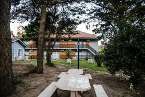 a picnic table in front of a house at Apart Valeria cerca del Mar in Valeria del Mar