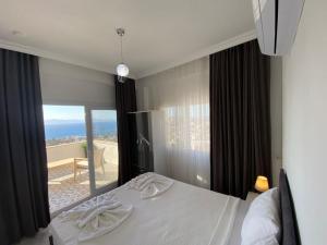 A bed or beds in a room at Bodrum eaSon Villa & House 350m2 Full Sea View with Private Infinity Pool