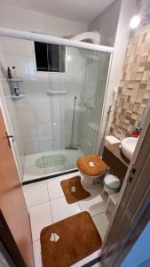 a small bathroom with a shower and a toilet at Cantinho dos Sonhos in Mangaratiba