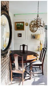 a dining room with a table and a mirror at The Stays - Private Cozy 2BHR Apt on main floor in Toronto