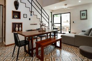 a living room with a table and a couch at Casa AMI in El Cuyo