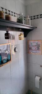 a bathroom with a shelf on the wall at Casa Azalea in Lainate +27 photos