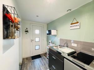 a kitchen with a sink and a counter top at Studio chic avec parking in Calais
