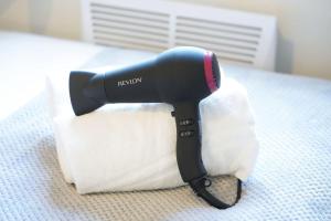 a hair dryer sitting on top of a piece of paper at Beautiful Apartment - Close to City Centre - Free Parking, Fast Wifi, SmartTV with Sky TV and Netflix by Yoko Property in Northampton +12 photos