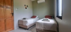 een kamer met 2 bedden in een kamer met een deur bij Parakreek Apartments in Boxel