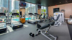 a gym with several tread machines and a pool at Beachwalk Resort Residence in Hollywood