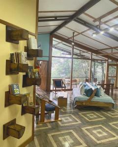 a living room with a bed in a room at Above the Gulf, Vacation House in Monteverde Costa Rica