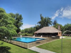 a swimming pool in a yard with a gazebo at Quinta Ferreyra in Villa Paranacito