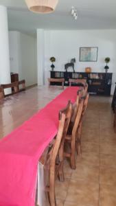 a long table with chairs and a red table cloth at Quinta Ferreyra in Villa Paranacito +95 photos