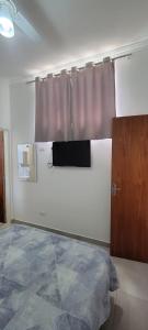 a bedroom with a bed and a window with a curtain at Apartamento Central in Artur Nogueira +4 photos
