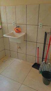 a bathroom with a sink and a broom at Aparecida apartamento Rone 3 in Aparecida