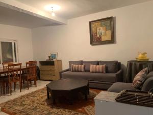 a living room with a couch and a table at Dar Al Hajja Fatima in Rabat