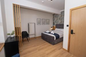 a hotel room with a bed and a mirror at Amber Hotel in Hull +16 photos