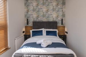 a bedroom with a bed with towels on it at Amber Hotel in Hull