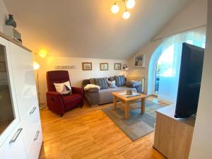 a living room with a couch and a tv at Frische Brise in Schönberger Strand