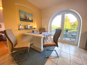 a living room with a table and chairs and an archway at Frische Brise in Schönberger Strand