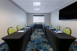 a conference room with long tables and chairs at Holiday Inn Express Spokane-Valley by IHG in Spokane Valley +64 photos
