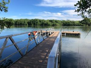 a dock on a lake with a boat on it at Explorer Isla Cañas in Isla de Cañas