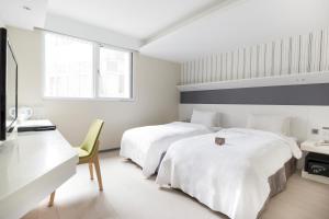 Postel nebo postele na pokoji v ubytování Dandy Hotel - Tianmu Branch