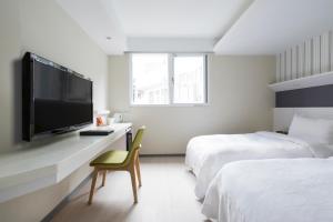Postel nebo postele na pokoji v ubytování Dandy Hotel - Tianmu Branch