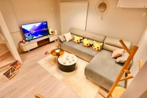 a living room with a couch and a flat screen tv at Metro 4 min to Shinjuku St Luxury Home in Shinjuku City in Tokyo