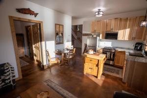 a kitchen with a table and a dining room at Kenai Living Waters - Fishing Paradise in Sterling