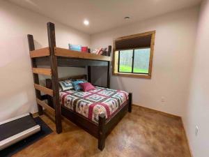 a bedroom with a bunk bed and a window at Kenai Living Waters - Fishing Paradise in Sterling