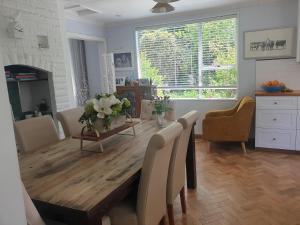 a living room with a wooden table and chairs at Windhaven Bed & Breakfast in Duntroon
